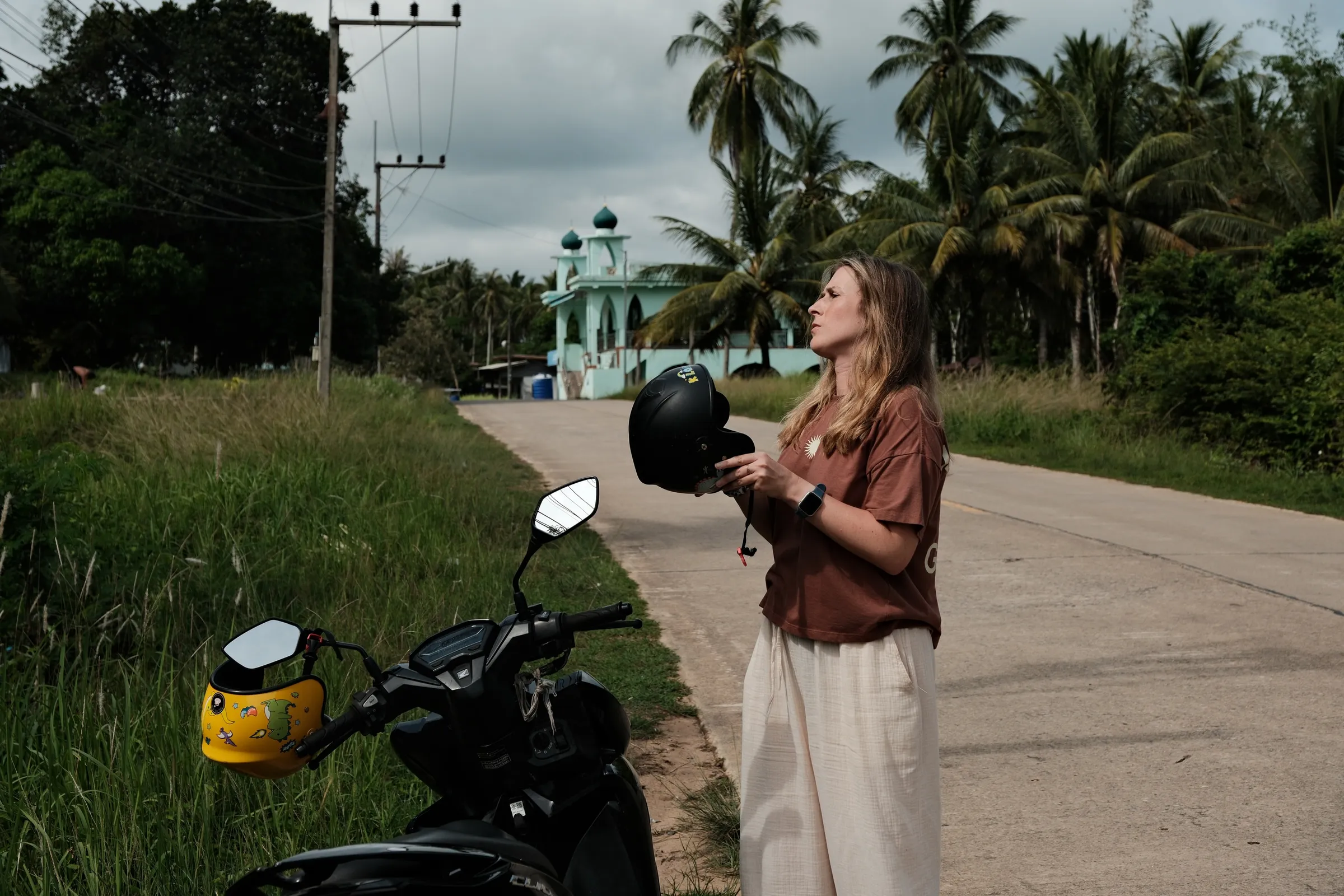 Helmets on, mosque behind